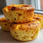 A close-up stack of three golden brown cottage cheese egg cups, similar to Starbucks style, ready to eat.