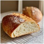 Cross-section view showing the airy, open crumb structure of a freshly baked Italian bread loaf.