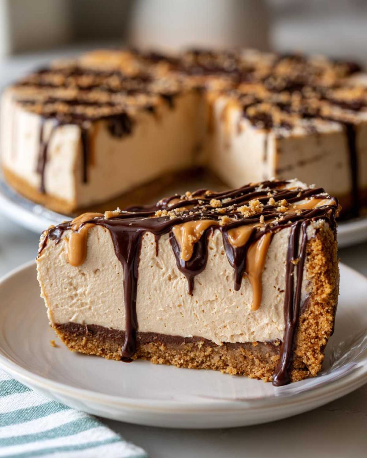 A decadent slice of no-bake peanut butter pie topped with chocolate and peanut butter drizzles.