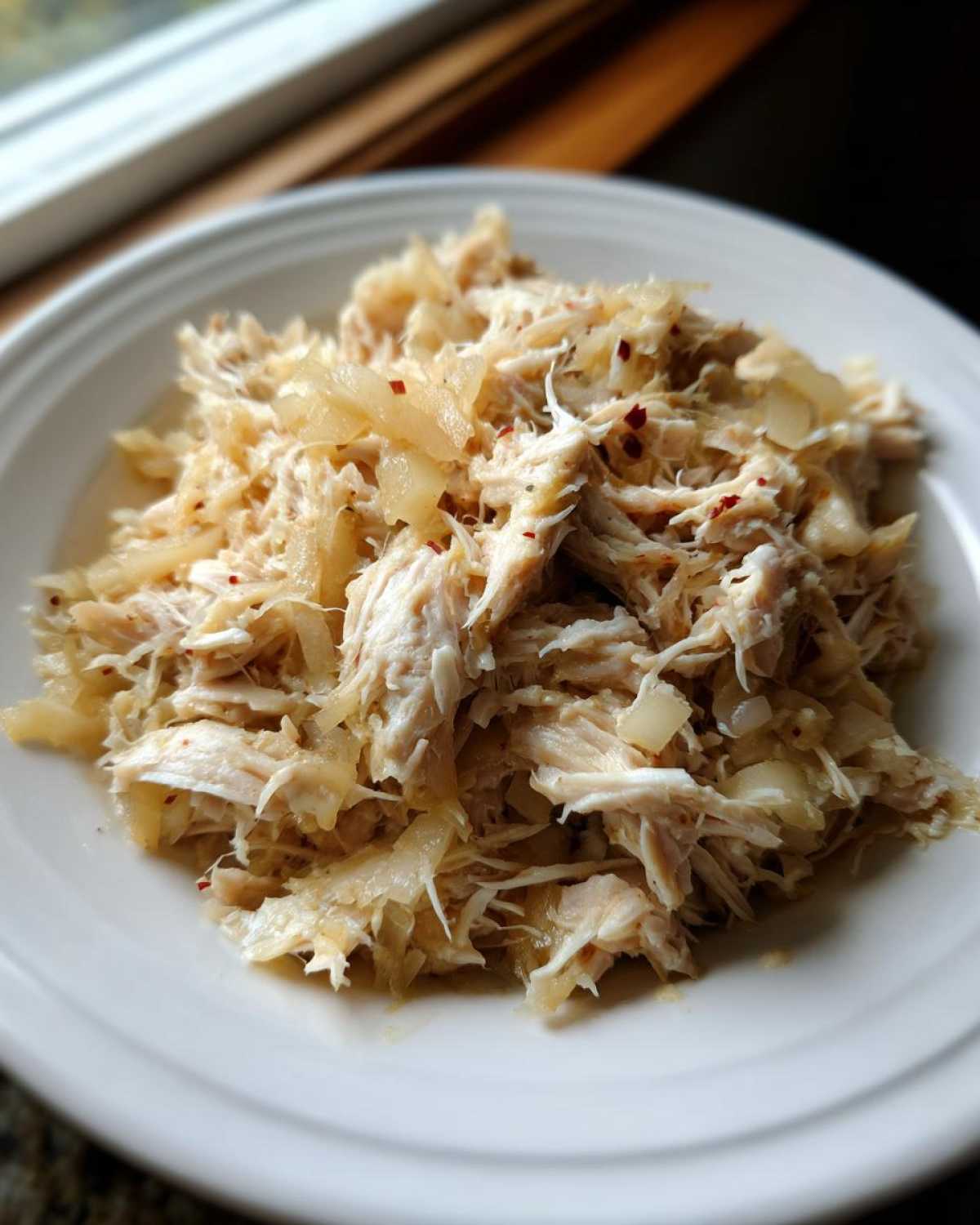 Close-up of shredded meat mixed with sauerkraut, representing the pork and sauerkraut recipe.