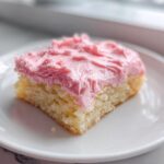 Close-up of a square slice of Copycat Crumbl Sugar Cookie with thick, bright pink frosting.