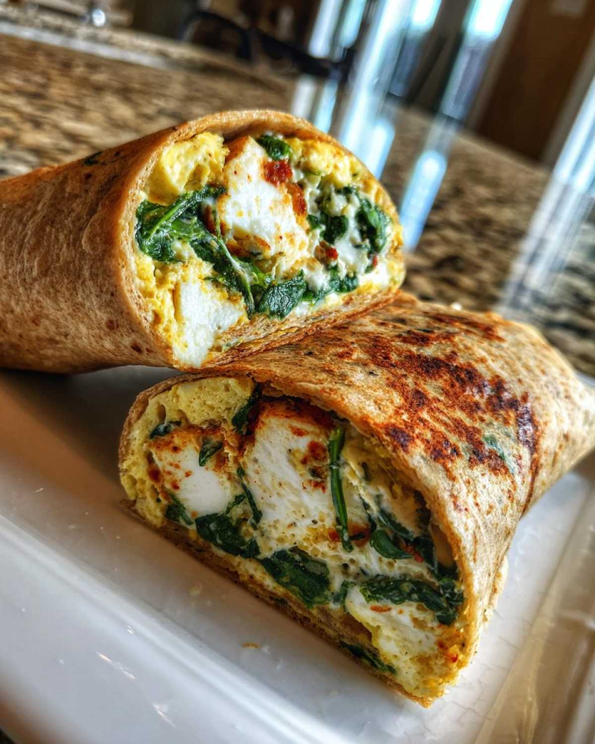 Cross-section of a High-Protein Egg White Breakfast Wrap filled with egg whites, spinach, and cheese.