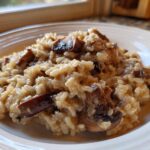 Close-up of creamy Instant Pot Creamy Mushroom Risotto with rich, browned mushroom pieces on a white plate.