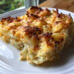 A close-up of a golden-brown slice of Easy 30-Minute Cheesy Side Dish on a white plate.