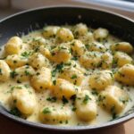 Close-up of Easy One-Pan Creamy Garlic Butter Gnocchi swimming in a rich sauce and topped with fresh parsley.