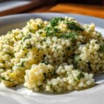 Close-up of fluffy Easy One-Pot Creamy Lemon Herb Couscous garnished with fresh dill and parsley.