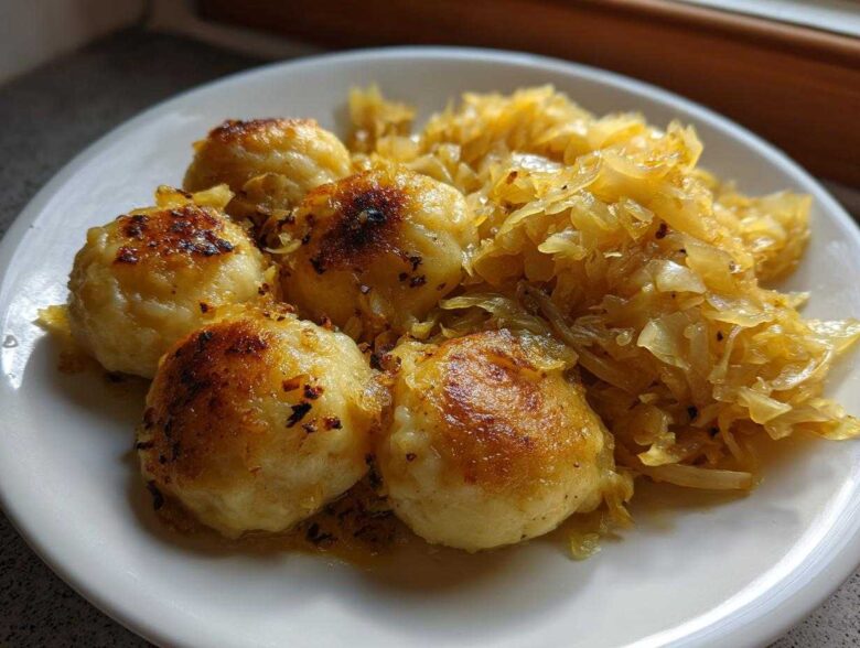 Close-up of pan-fried German Dumplings With Buttered Cabbage served on a white plate.