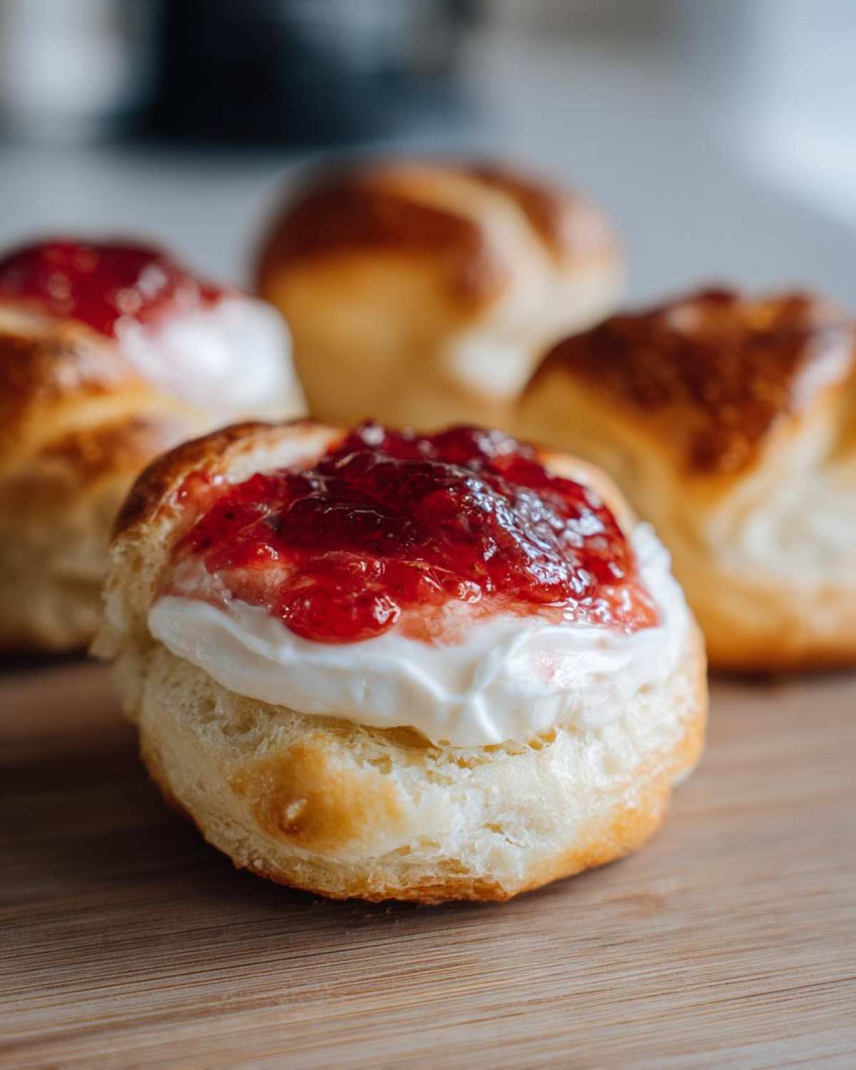 Close-up of a Gluten-Free Strawberry Cream Cheese Danish topped with cream cheese and strawberry jam.