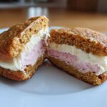 Close-up of a Gluten-Free Strawberry Lemon Whoopie Pie cut in half showing two layers of filling.