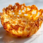 Close-up of a perfectly baked, golden-brown Keto Crispy Cheese Taco Shell Bowl with lacy edges.