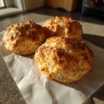Three golden brown Keto Everything Bagel Cloud Bread buns topped generously with everything bagel seasoning.