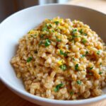 Close-up of creamy One-Pot Creamy Lemon Garlic Farro topped with parsley and lemon zest.
