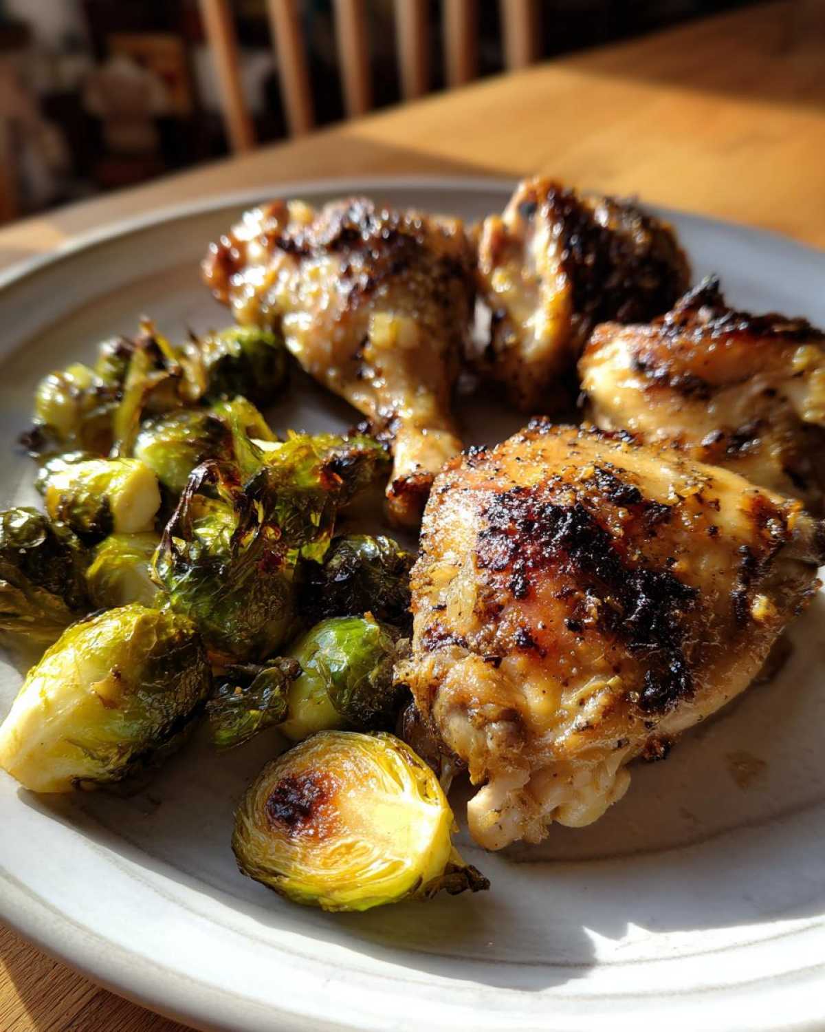 Portion of Sheet Pan Garlic Butter Chicken and Brussels Sprouts served on a plate.