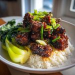 Close-up of a Vegan Crispy Sesame Tempeh Bowl featuring glazed tempeh, white rice, and bok choy.